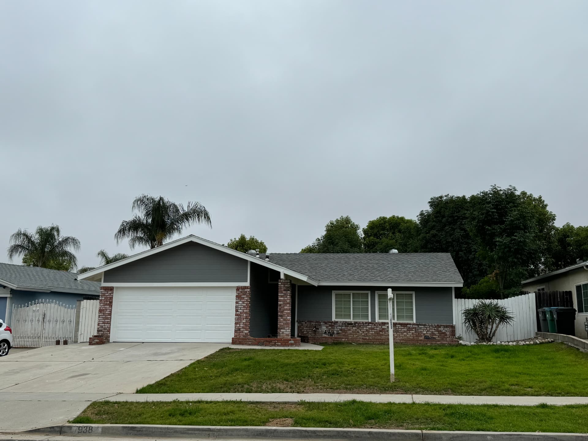 Single-story home with new gray paint and roof